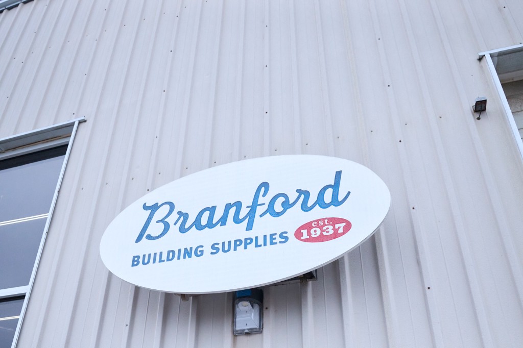 Branford Building Supplies exterior sign on corrugated metal — est. 1937