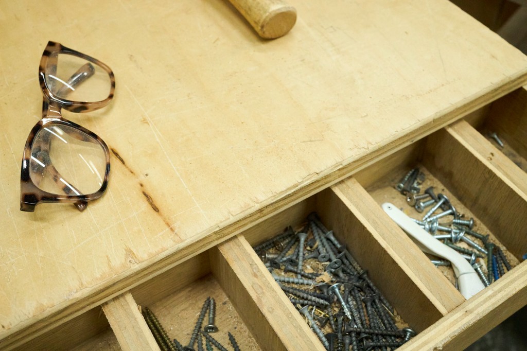 Workbench detail — hardware organizer, fasteners, and everyday shop precision