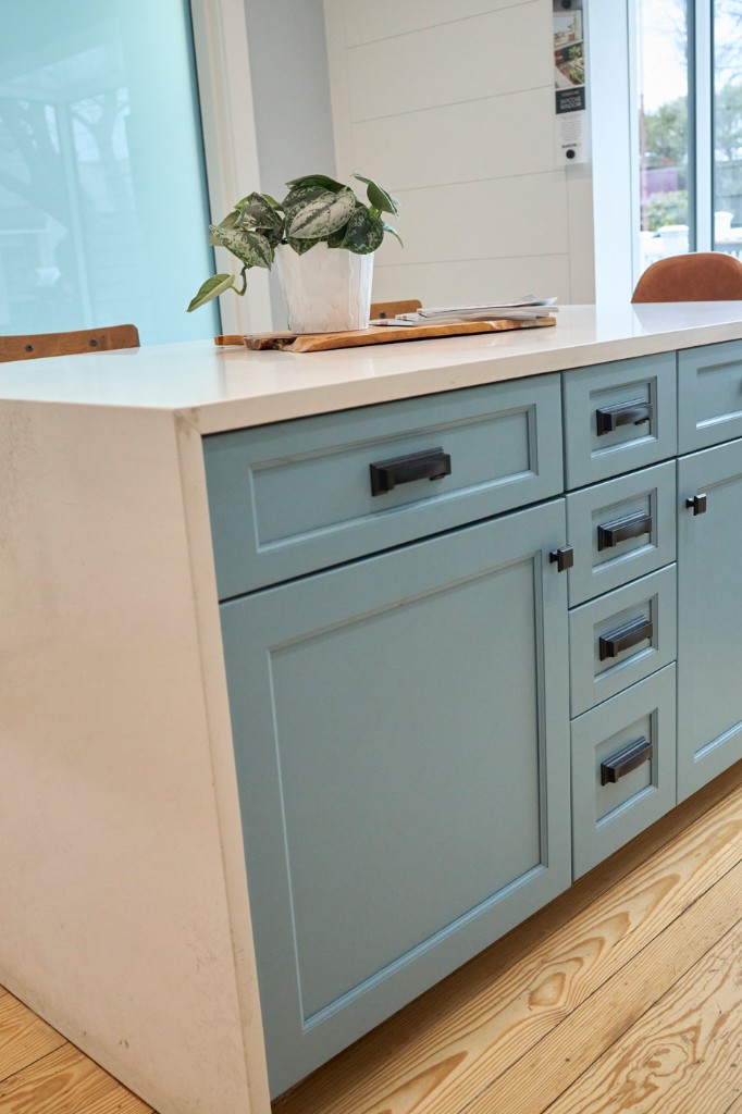 Hands aligning curved architectural molding for quality control