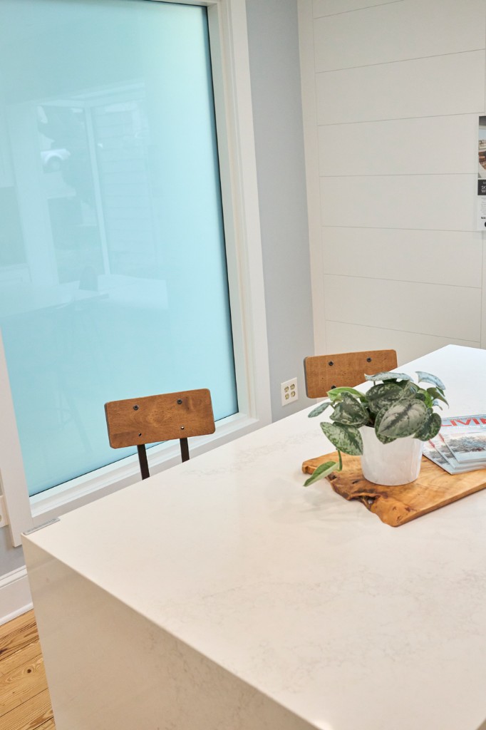 Showroom display island — painted cabinetry, matte hardware, waterfall countertop