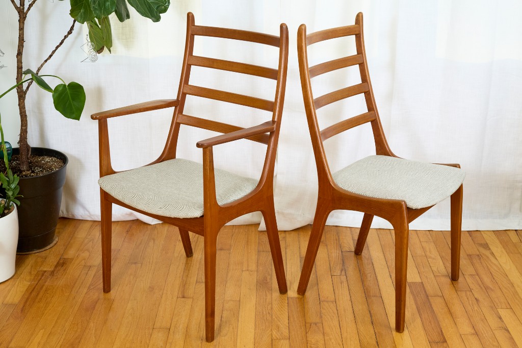 Armchair and side chair paired — ladder backs on hardwood