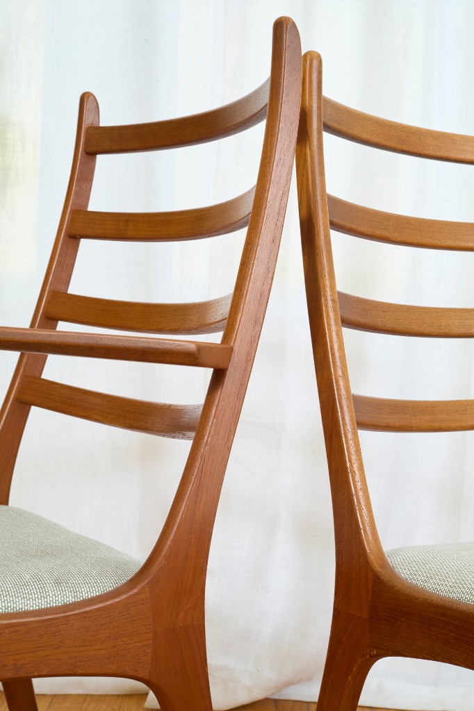 Side profile — two ladder-backs against sheer curtain light